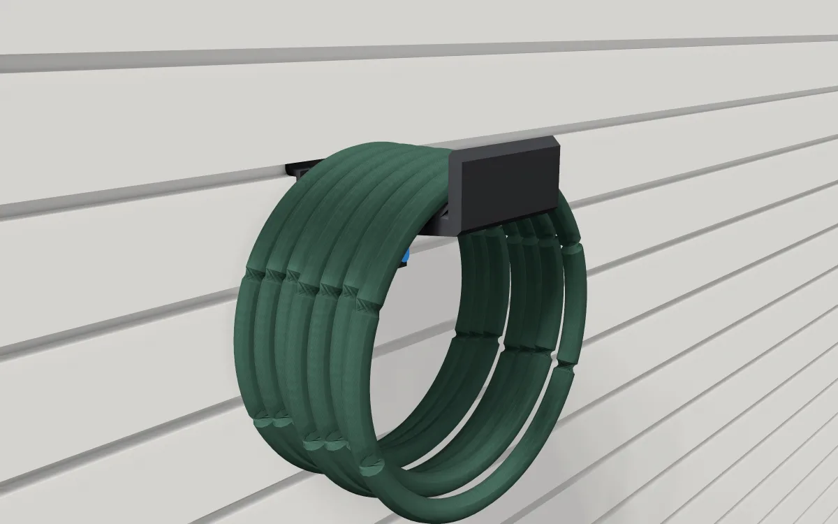 Hose saddle on slatwall, holding a coiled garden hose