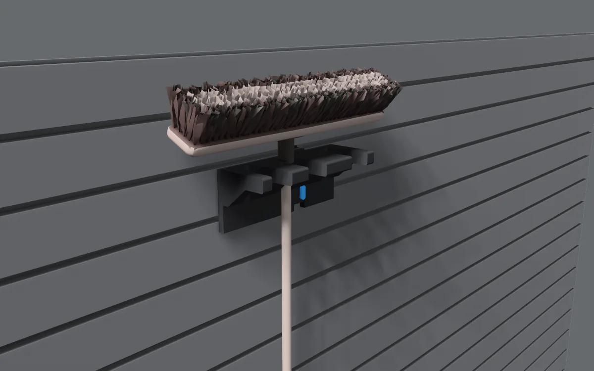Long-handle tool rack on slatwall, holding a broom
