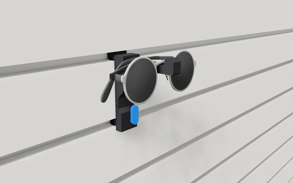 Safety-glasses rack on slatwall, holding a pair of glasses